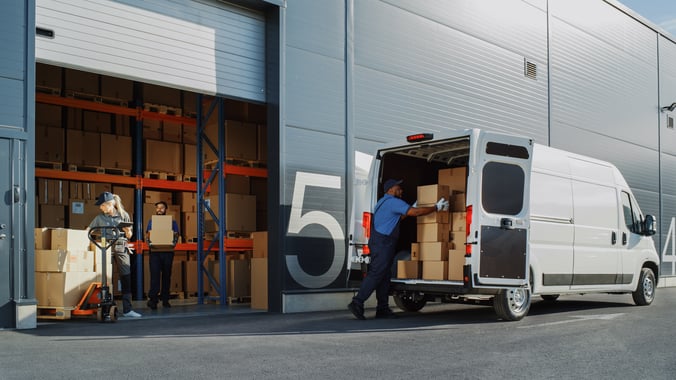 Workers getting a delivery truck ready to leave the warehouse for 3PL last mile delivery