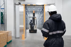 Employees Working in the Cold Storage Area of a Warehouse - Smart Warehousing