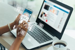 Person Shopping Online with Phone and Laptop - Smart Warehousing